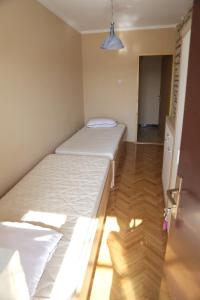 a small bedroom with two beds in a room at Apartment 51 in Gornji Karin