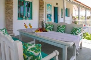 a table with a bowl of fruit on a patio at Georgia Villas in Skiathos