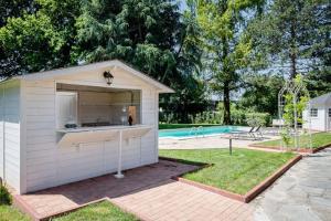a small shed in a yard with a pool at Villa Sequoia in Leinì