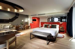 a hotel room with a bed and a living room at Hard Rock Hotel Tenerife in Adeje