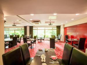 a restaurant with tables and chairs and a red carpet at The Bridge House Hotel in Reigate