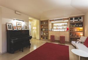 a living room with a couch and a piano at Villa Martini in Castiglioncello