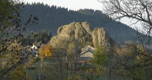uma grande montanha rochosa no meio de uma floresta em leKarl em Queyrières