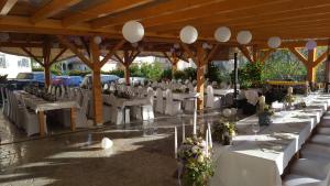 a group of tables and chairs in a pavilion at Pansion Dragica in Rab