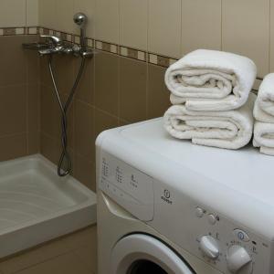 a washing machine with towels on top of it in a bathroom at Cretan Blu Platanias in Platanias