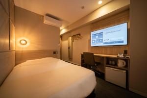 Postel nebo postele na pokoji v ubytování Super Hotel Tottori Ekimae