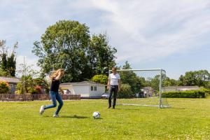 a man and a woman playing soccer in a field at TopParken – Parc IJsselhoeve in IJssellaan