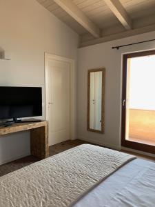 A bed or beds in a room at Borgo Al Tempo Perduto