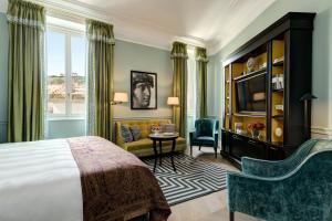 a hotel room with a bed and a living room at Rocco Forte Hotel De La Ville in Rome