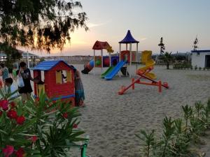 a playground with children playing on the beach at Beach Garden Home, Lalzi Bay in Durrës