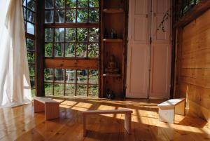 an empty room with a large window and benches at Hostal Casa Amaya in Vallehermoso