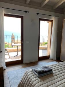 a bedroom with a bed and a view of the ocean at Borgo Al Tempo Perduto in Gargnano