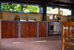 a kitchen with wooden cabinets and a sink and a stove at Podere di Maggio - Canvas tent Chestnut in Santa Fiora