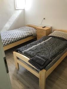 two twin beds in a room with a desk at Haus Jörg in Lutter