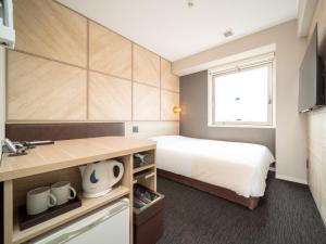 Postel nebo postele na pokoji v ubytování Super Hotel Tottori Ekimae