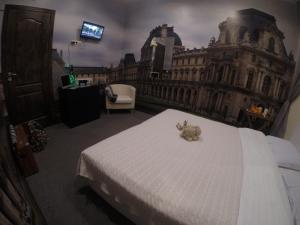 a bedroom with a bed with a teddy bear on it at Мини-отель Жуковского 14 in Saint Petersburg