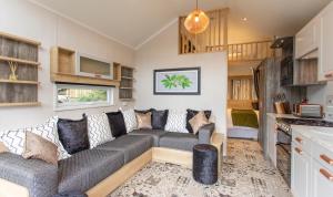 a living room with a couch and a kitchen at Aberdunant Hall in Porthmadog