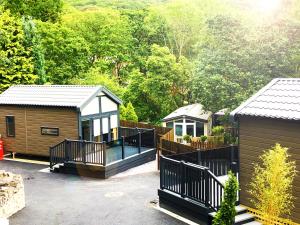 a house with a deck and a house with trees at Aberdunant Hall in Porthmadog