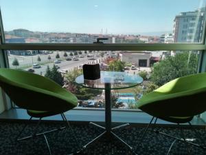 a room with a table and two chairs and a window at Inci Class Hotel in Denizli