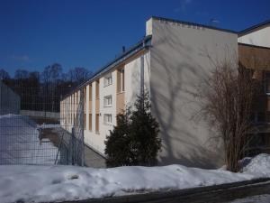 a building with snow on the side of it at Dom Sportowca Roko in Gdańsk