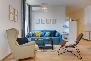 salon z niebieską kanapą i krzesłem w obiekcie APARTMENTS NOVAK w Puli