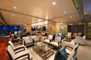 a living room with couches and chairs and a table at Simola Hotel, Country Club & Spa in Knysna