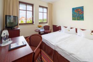 Letto o letti in una camera di Kim Hotel Dresden