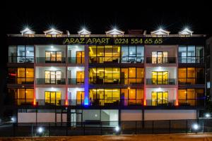 an apartment building at night with lights on at Araz Suit Otel in Burgaz