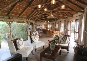 a living room with chairs and a table in a building at Woodbury Tented Camp – Amakhala Game Reserve in Amakhala Game Reserve