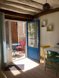 a door to a patio with chairs and a table at L'Estancat in Pardies-Piétat