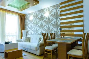 a living room with a couch and a table at Sweet Homes Apartments in Sunny Beach