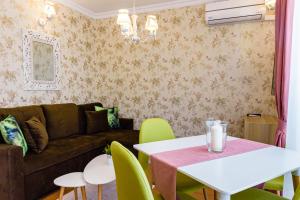 a living room with a couch and a table and chairs at Sweet Homes Apartments in Sunny Beach