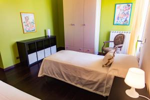 a bedroom with green walls and a bed with a chair at Casa Bea in Fasano