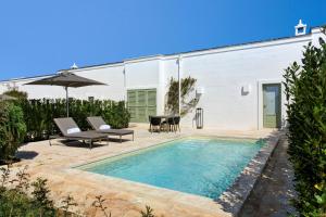a swimming pool in the backyard of a house at Rocco Forte Masseria Torre Maizza in Savelletri di Fasano
