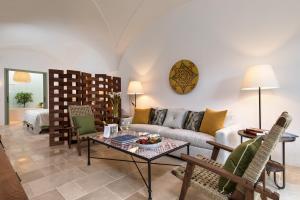 a living room with a couch and a table at Rocco Forte Masseria Torre Maizza in Savelletri di Fasano