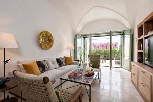 a living room with a couch and a table at Rocco Forte Masseria Torre Maizza in Savelletri di Fasano