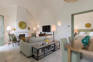 a living room with a couch and a table at Rocco Forte Masseria Torre Maizza in Savelletri di Fasano