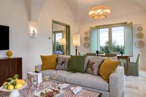 a living room with a couch and a table at Rocco Forte Masseria Torre Maizza in Savelletri di Fasano