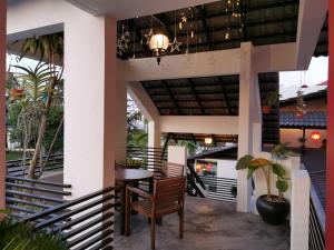 a patio with a table and chairs on a house at Millenium maison home in Alor Setar