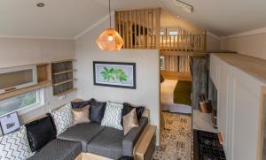 a living room with a couch in a tiny house at Aberdunant Hall in Porthmadog