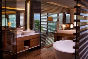 a bathroom with a tub, toilet and sink at The View Lugano in Lugano