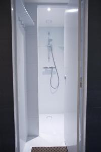 a shower stall with a shower door open at St Christopher's Greenwich in London