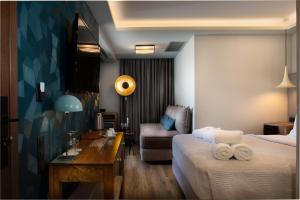 a bedroom with a large bed and a large window at 360Degrees Pop Art Hotel in Athens