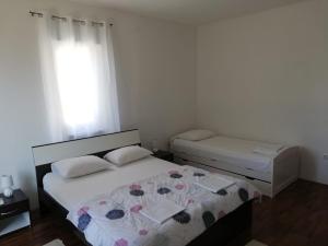 Postel nebo postele na pokoji v ubytování Apartments Alexa