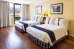 a hotel room with two beds and a window at Holiday Inn Lisbon by IHG in Lisbon