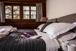 a bedroom with a bed with two books on it at Chalet Feekatz in Saas-Fee