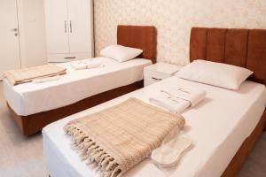 a room with two beds with towels on them at Araz Suit Otel in Burgaz