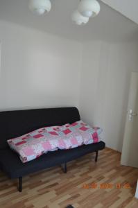 a bed with a quilt on it in a room at Ferienwohnung Pitz in Saarbrücken