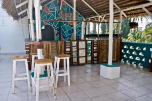 a room with stools and a wall with a mural at Cefa Hostel in Dar es Salaam