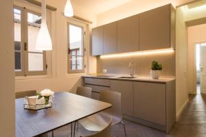 a kitchen with a table and chairs and a sink at Apartments Florence - Duomo Contemporary in Florence